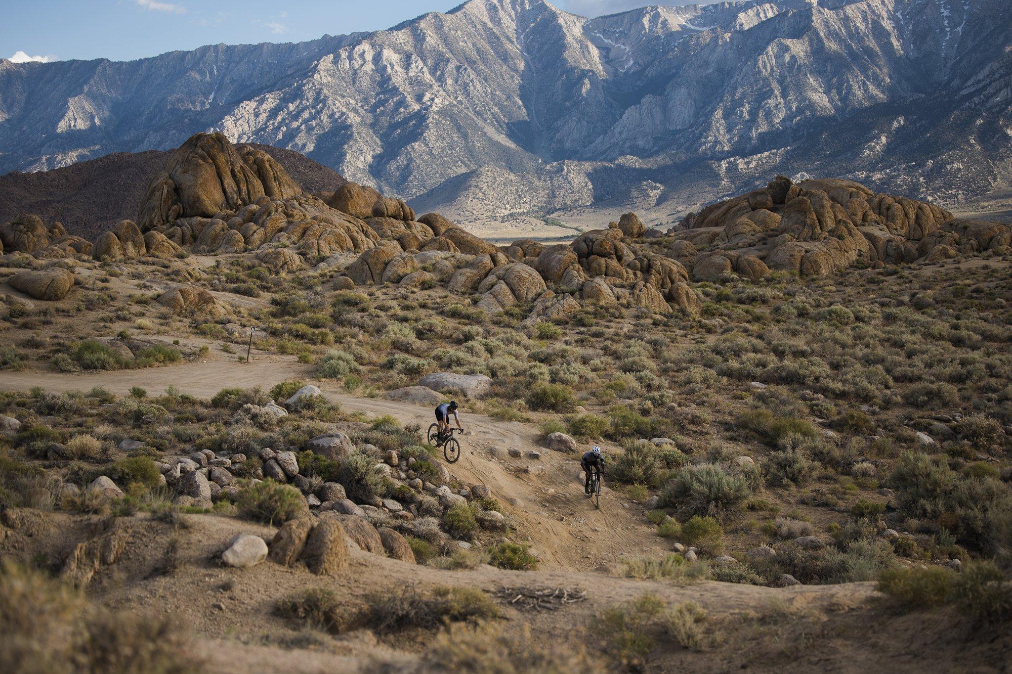 gravel riders in beautiful scenery with mountains in background