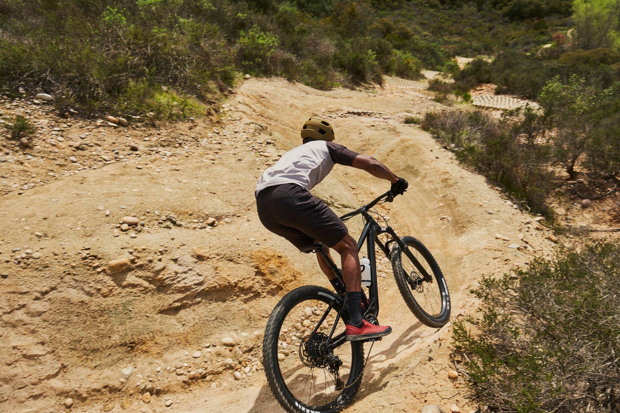 a man riding a mountain bike down a dirt trail