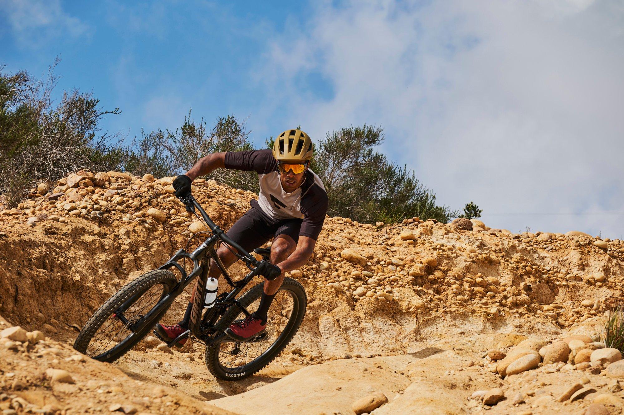 a man riding a mountain bike on a dirt trail