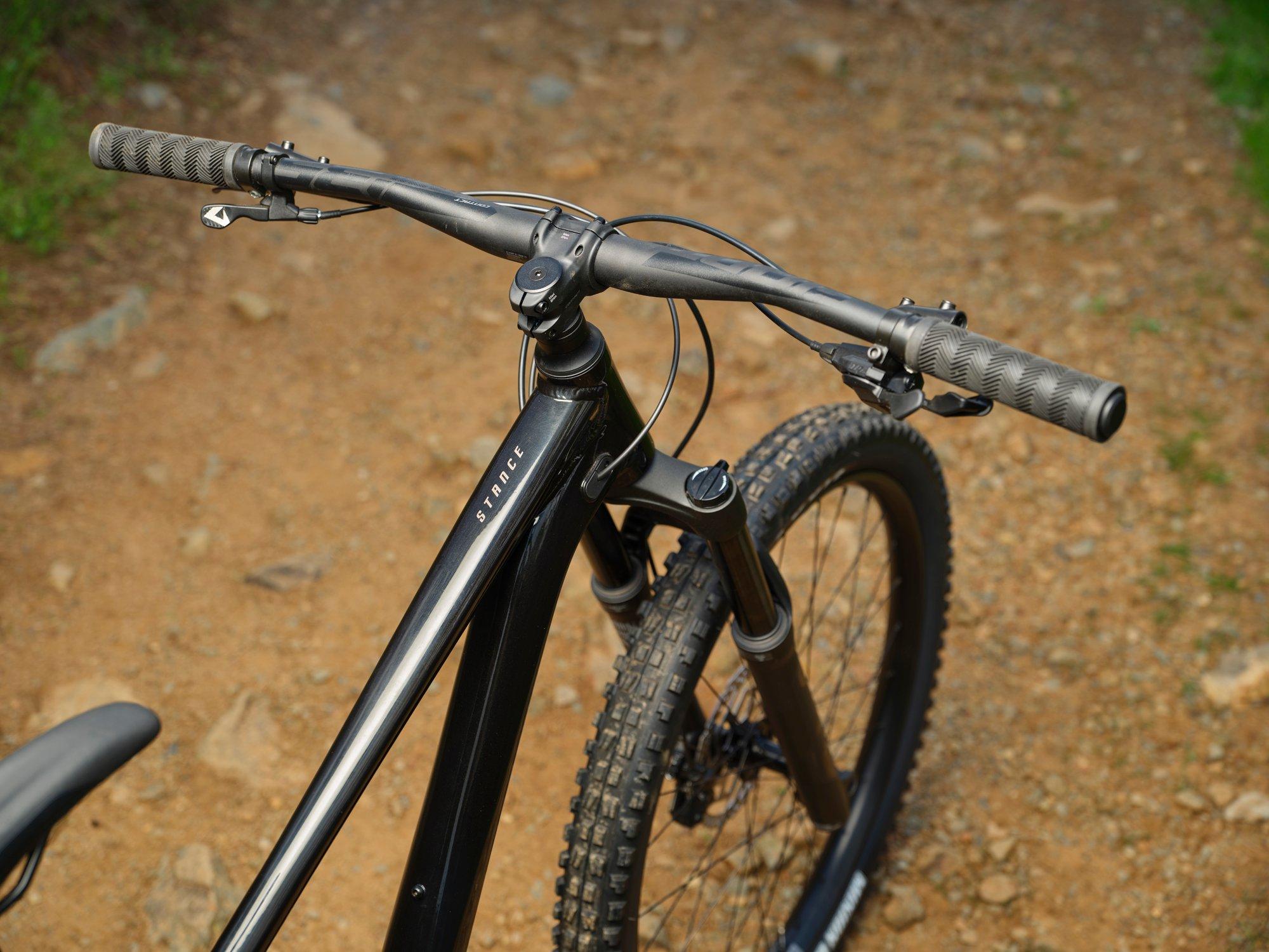a close up of a mountain bike on a dirt road