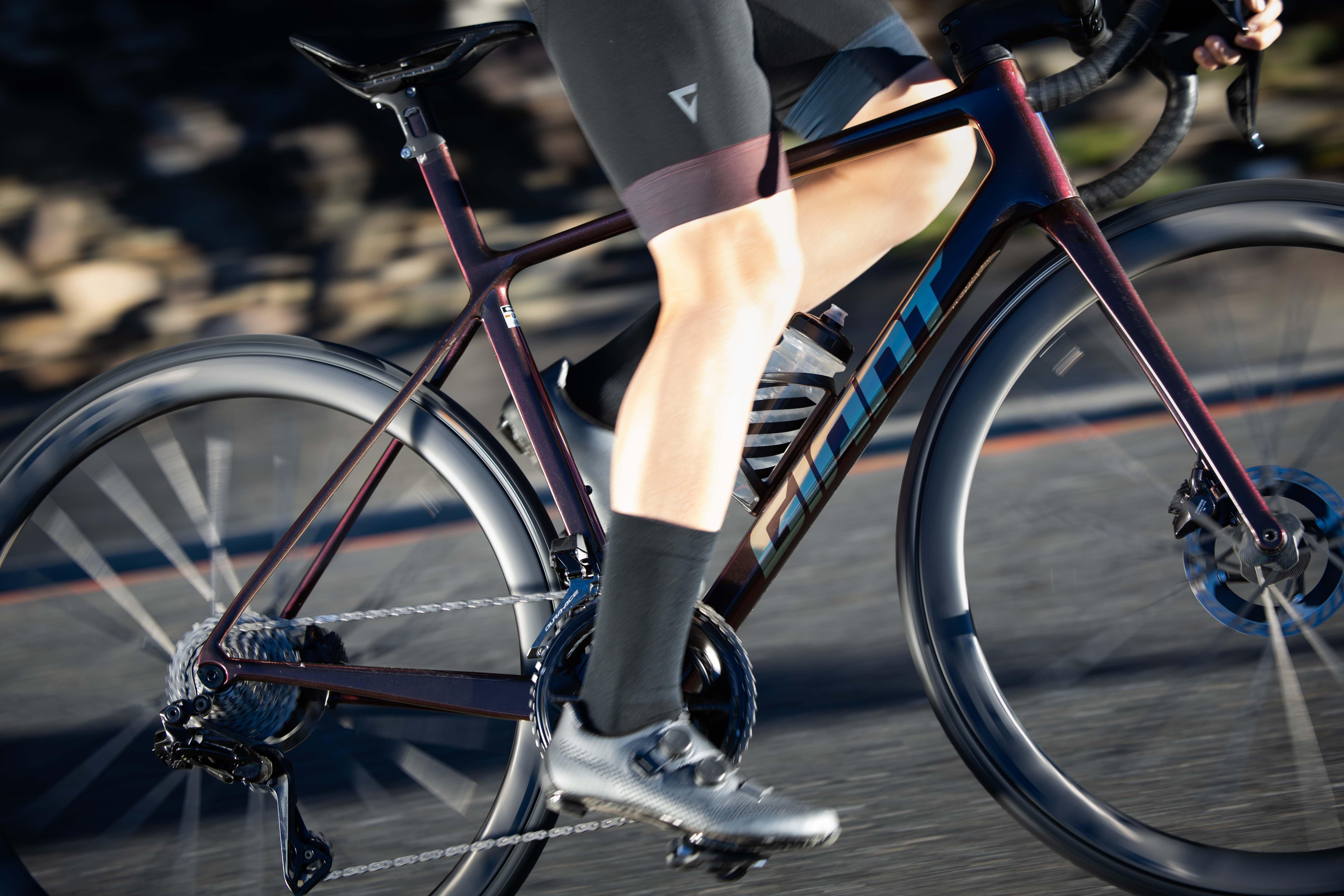 a close up of a person riding a bike on a road