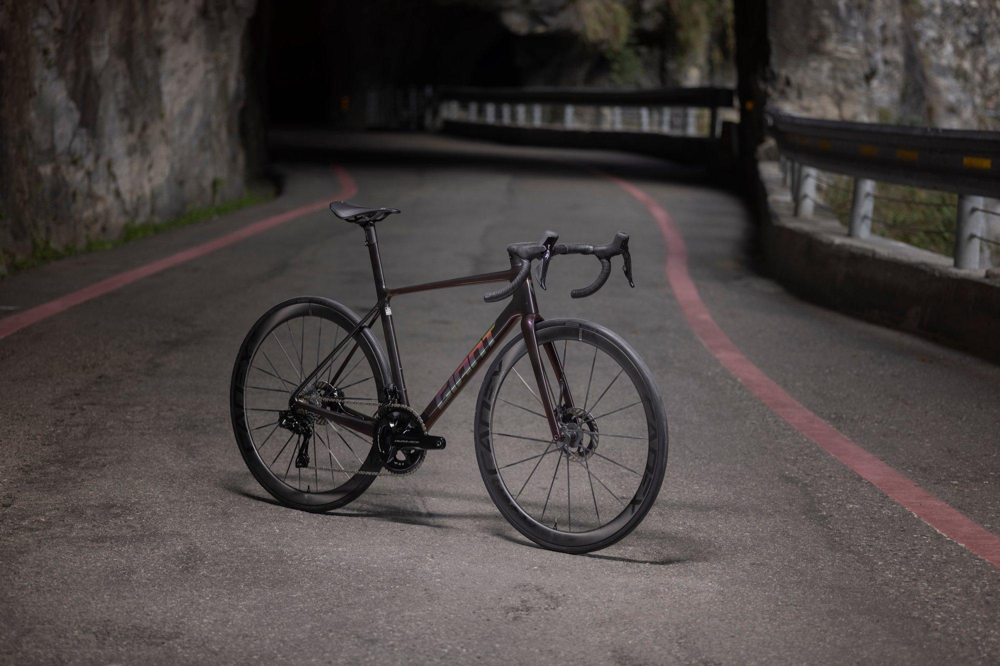 a bicycle is parked on the side of a road in a tunnel