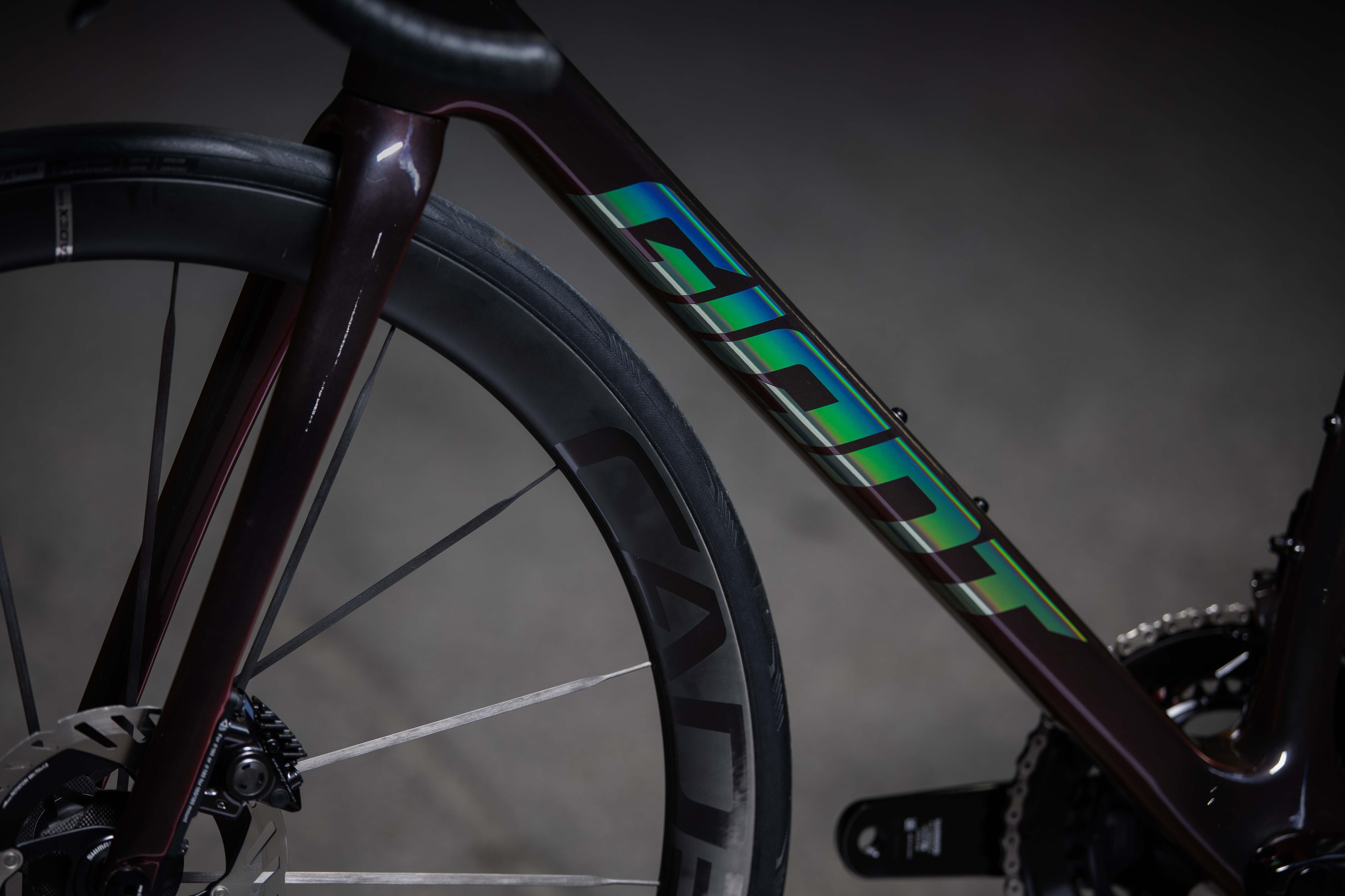 a close up of a bicycle with a green and blue stripe