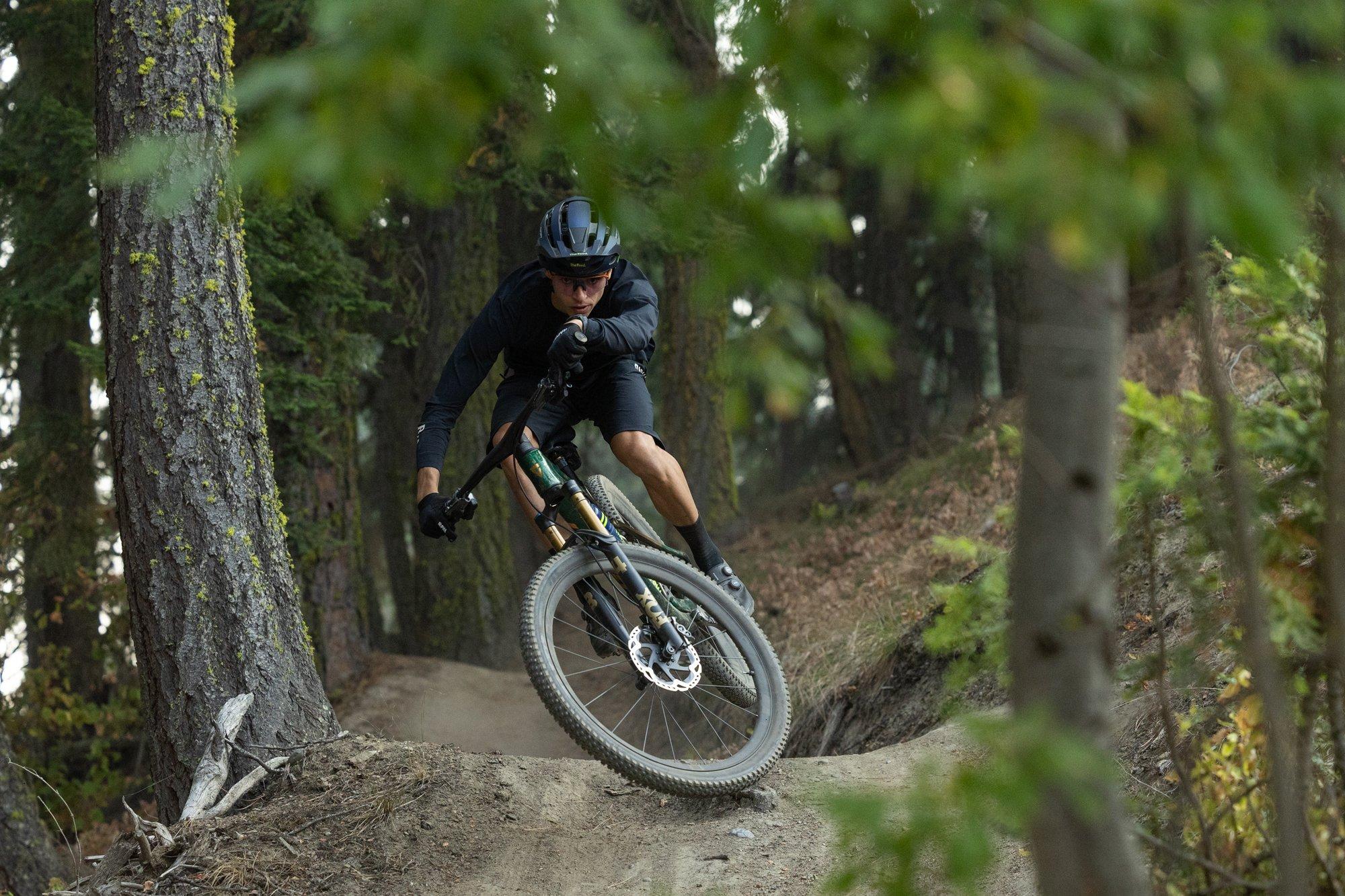 a man riding a mountain bike on a rocky trail