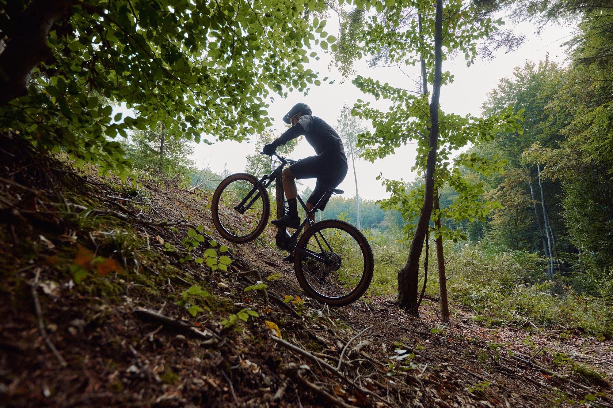 a person riding a mountain bike down a steep hill