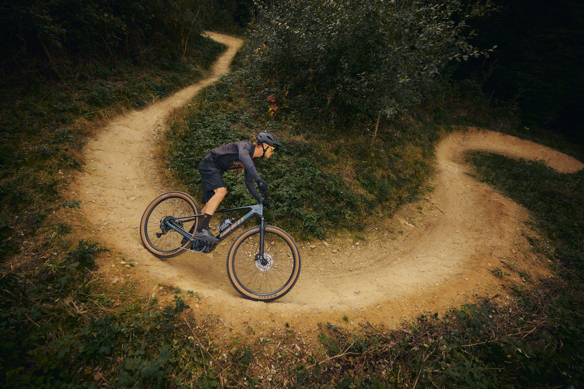 a man riding a mountain bike on a dirt trail
