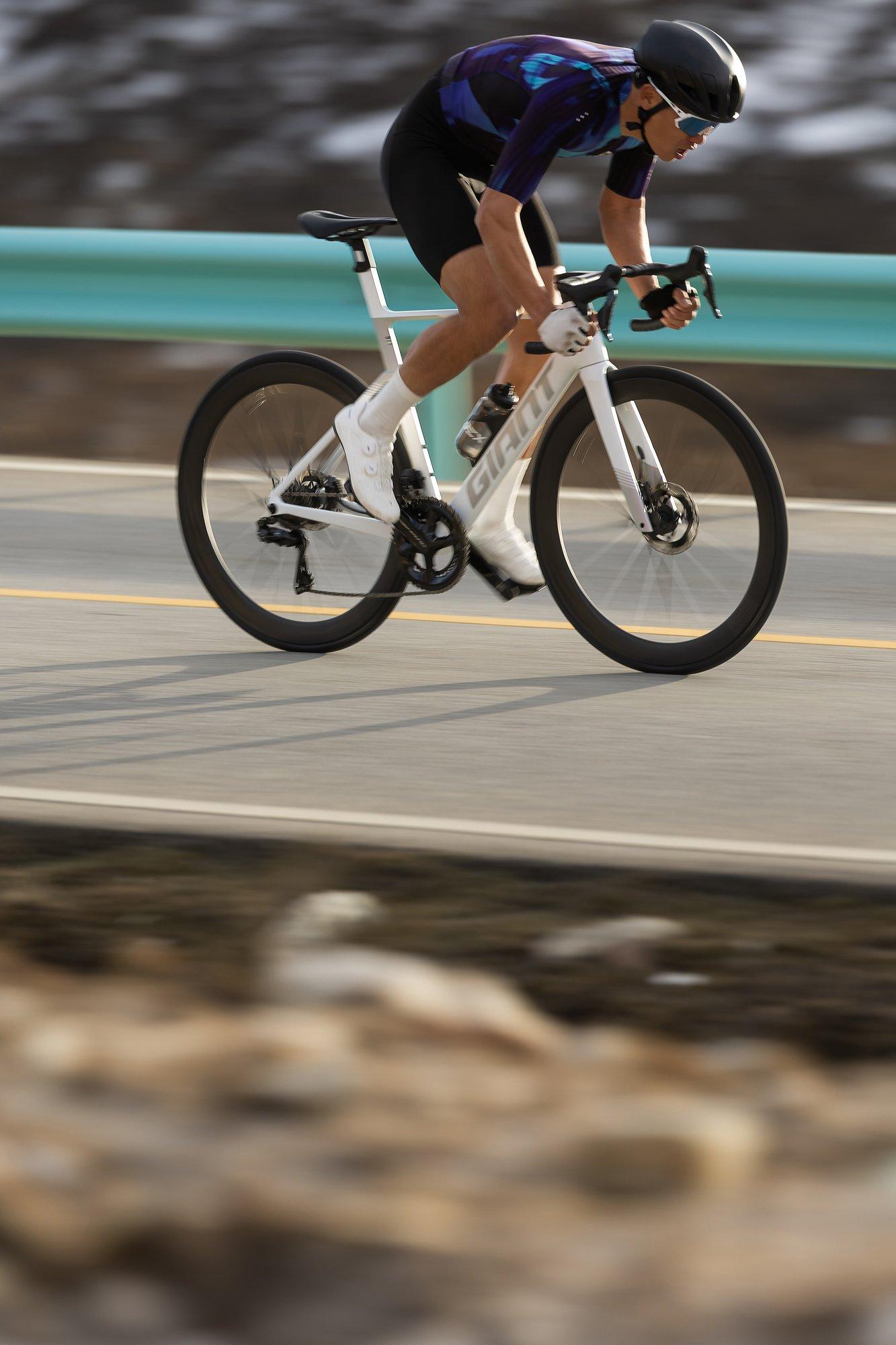 a man riding a bike on a road 