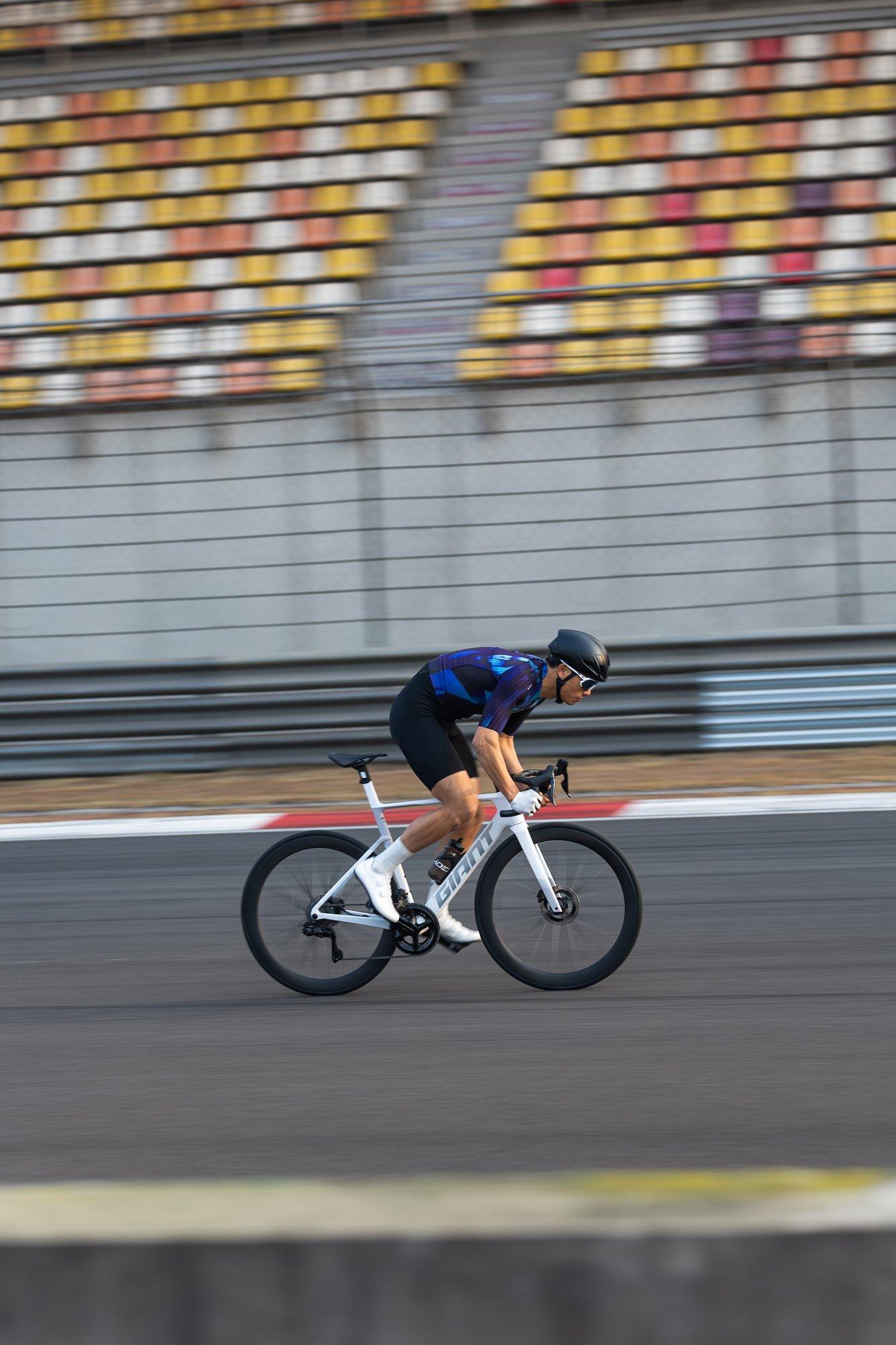 man riding a road bike on a track