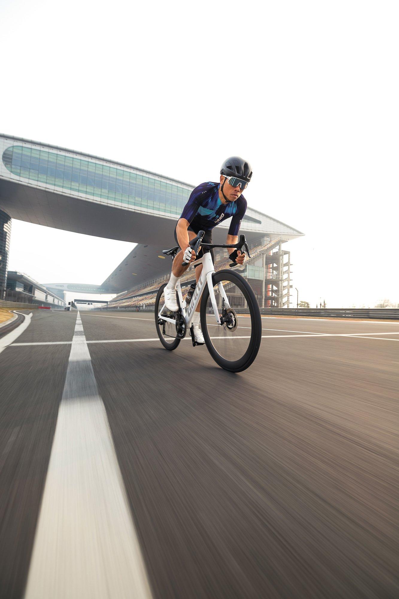 man riding a road bike on a track