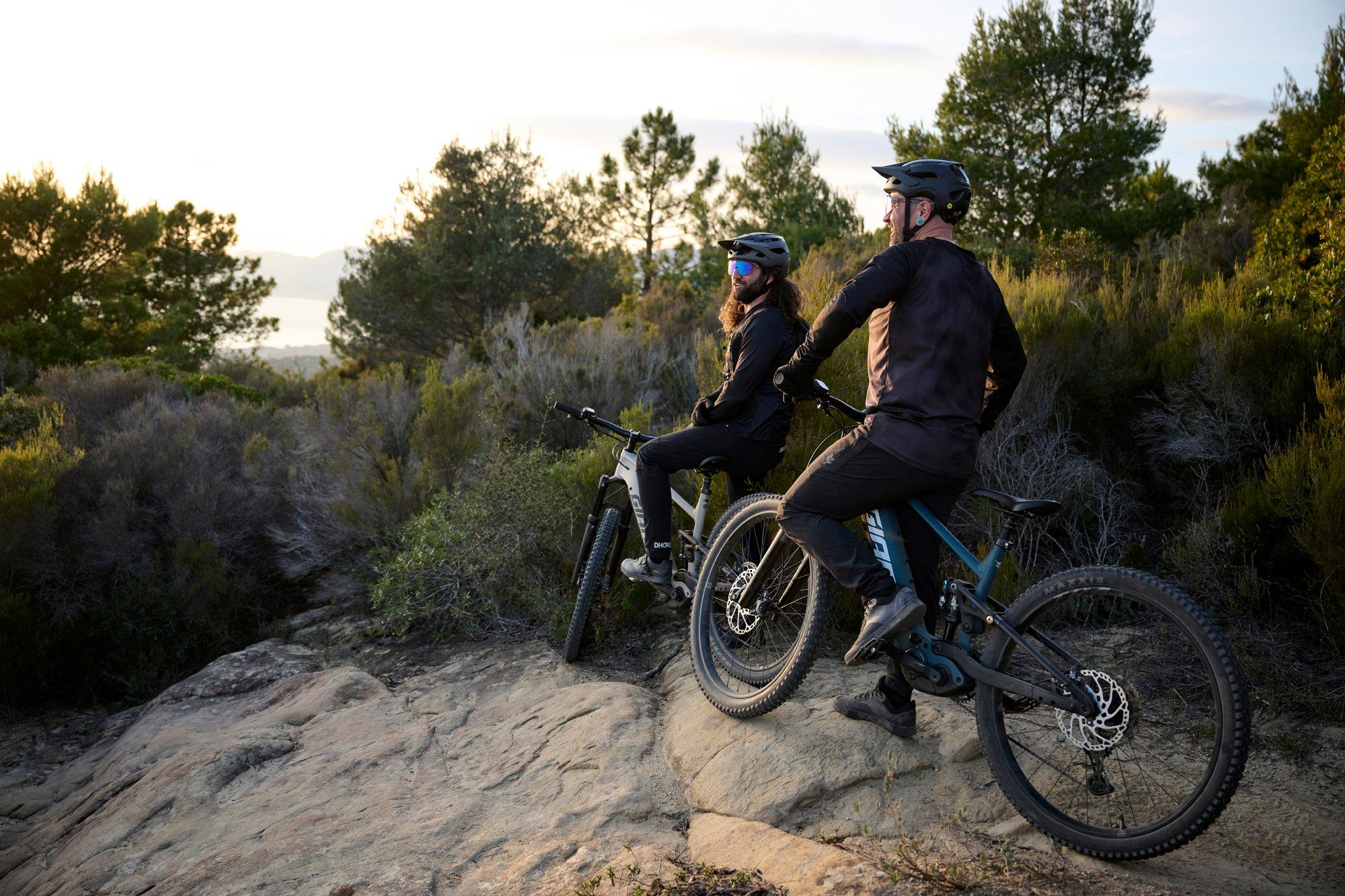 two men on mountain bikes on a rocky hillside