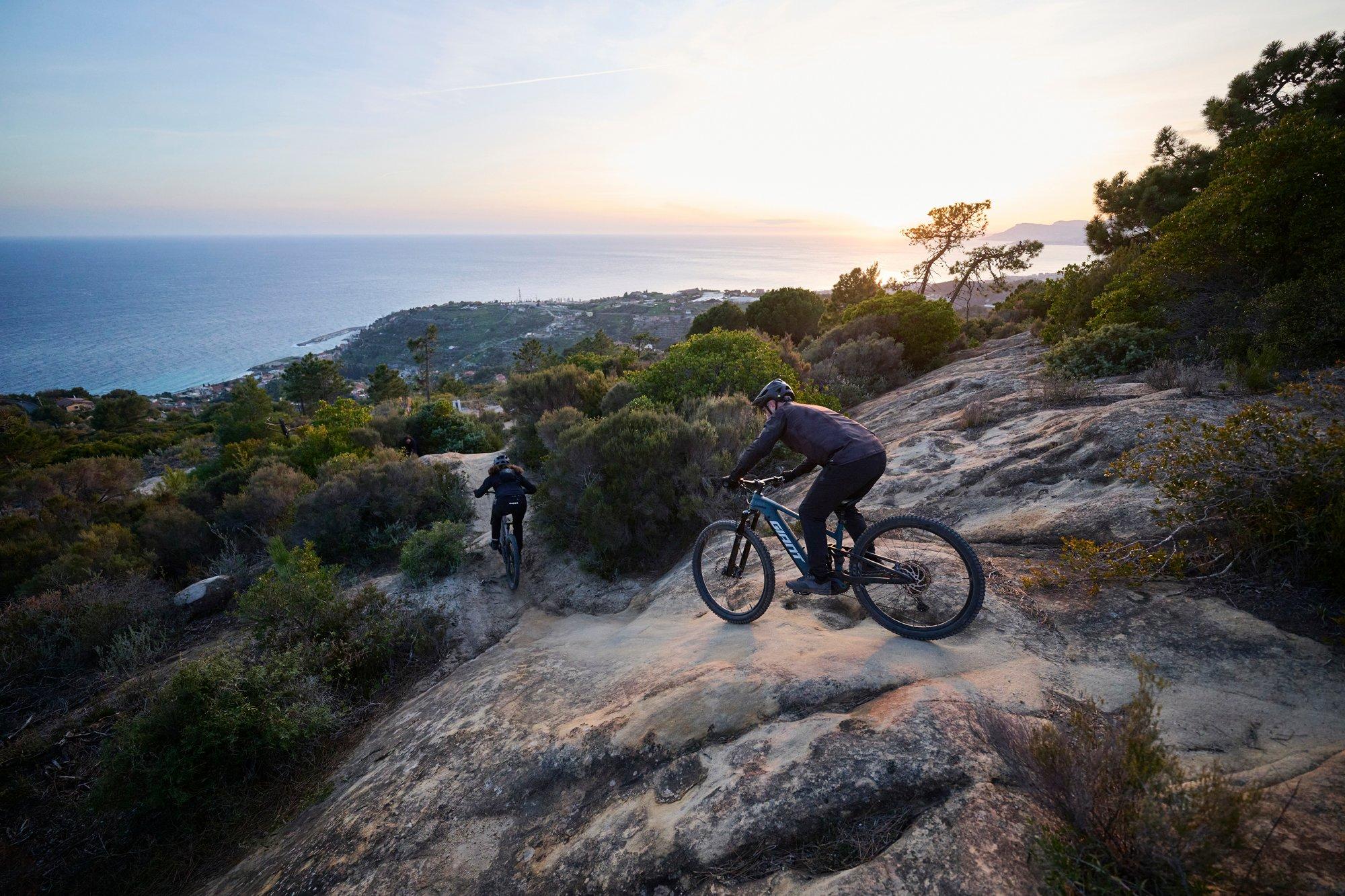 a man riding a mountain bike on a rocky trail