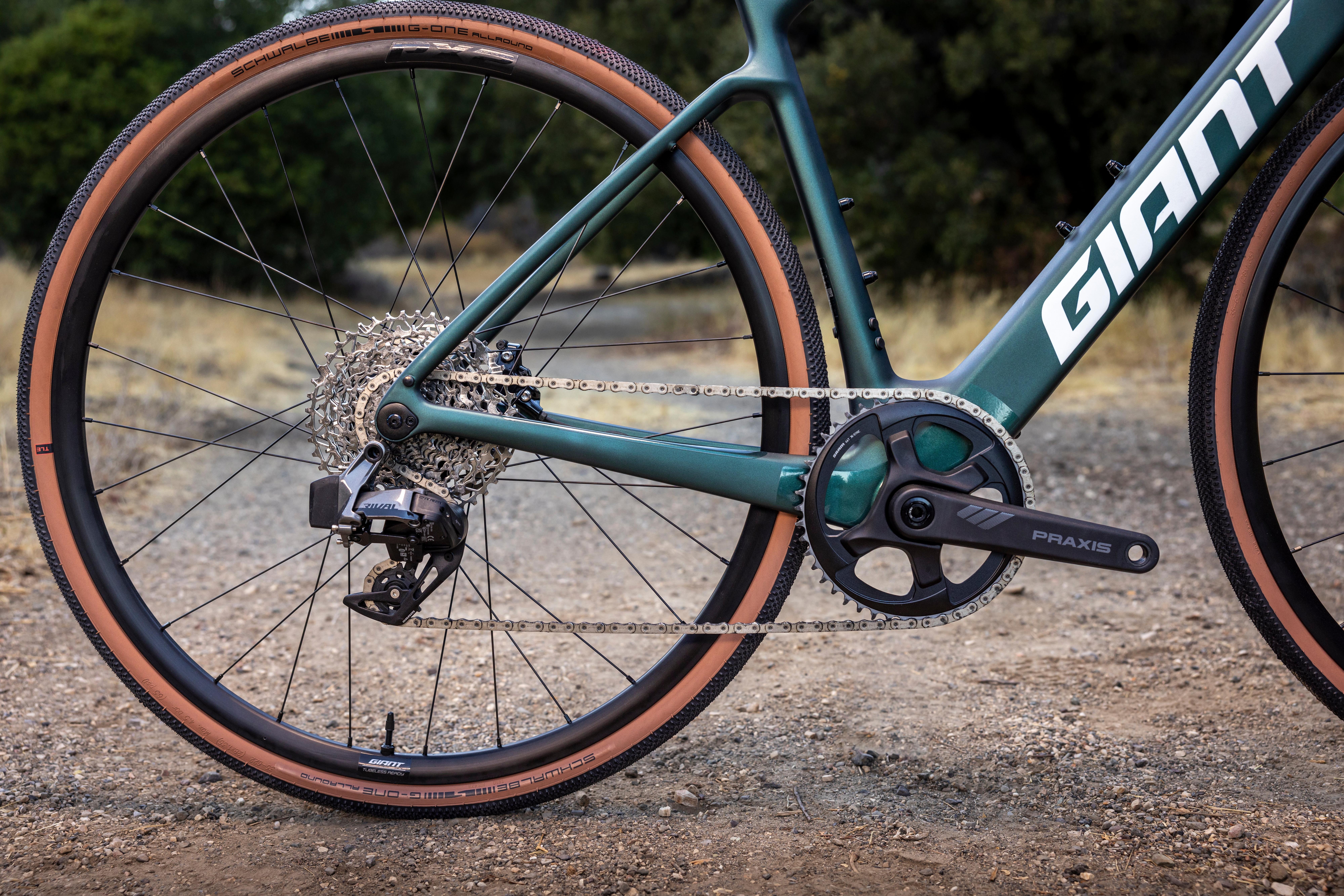 a close up of a green bike on a dirt road