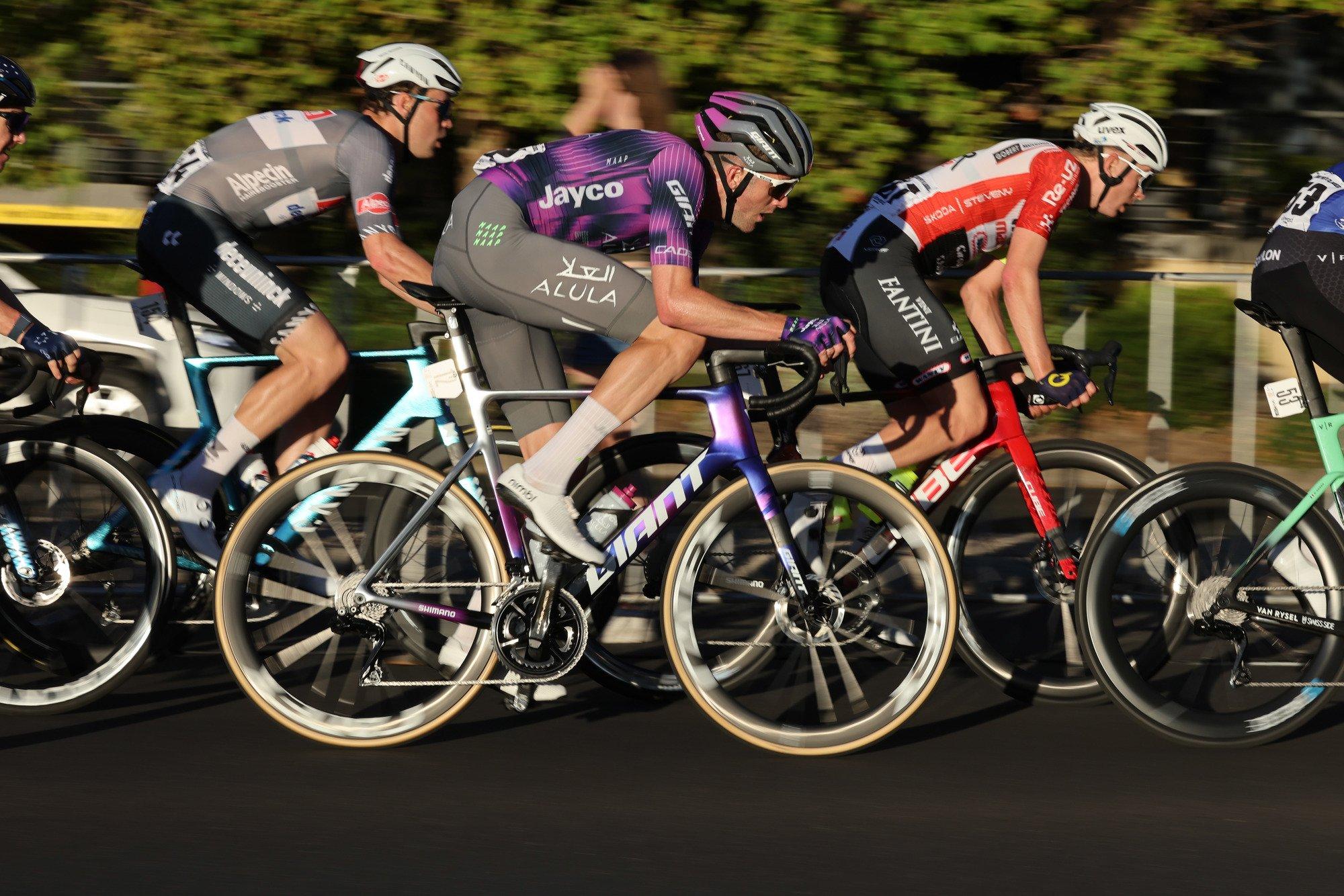 a group of cyclists are racing down a road together