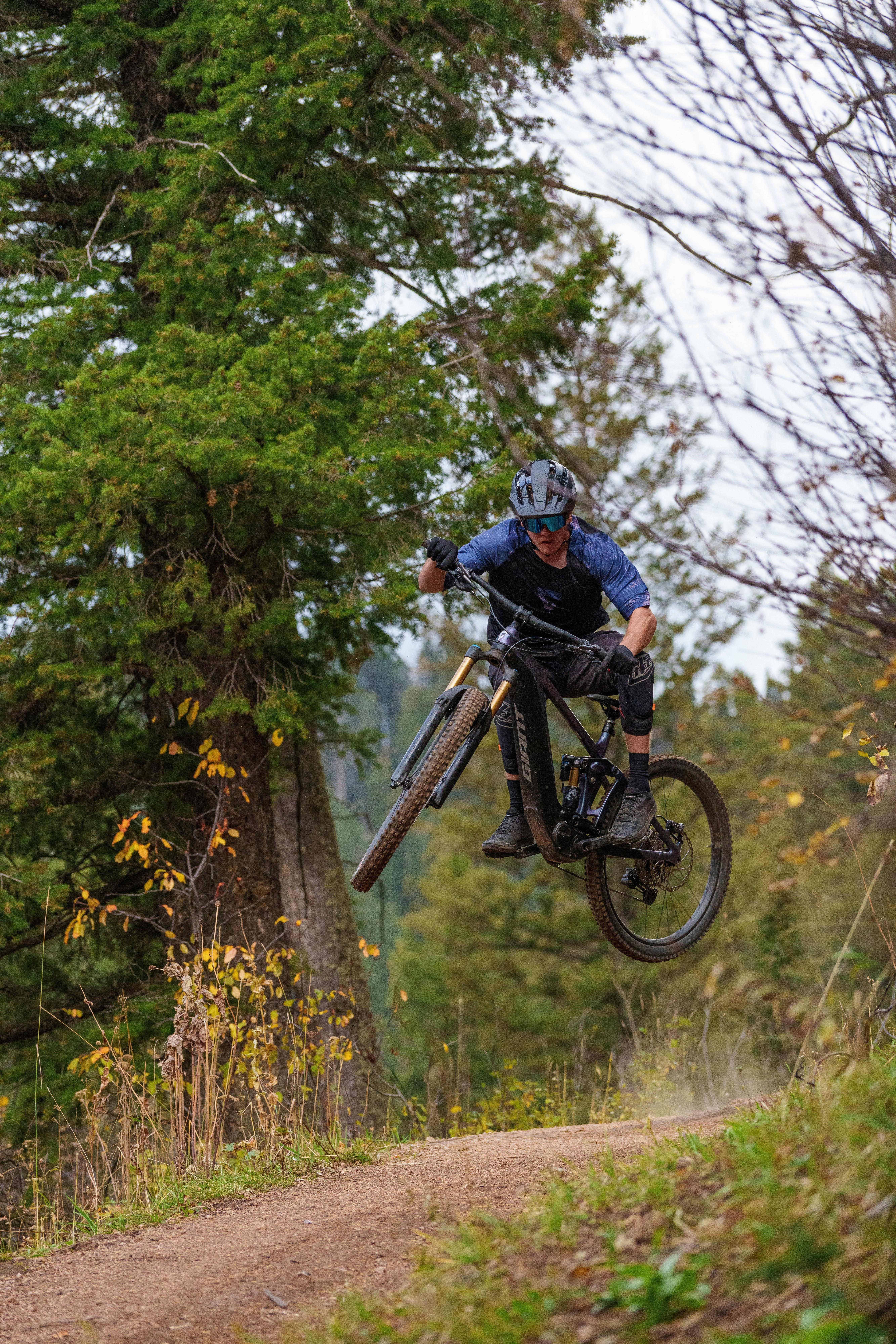 a man on a mountain bike jumping a small hill
