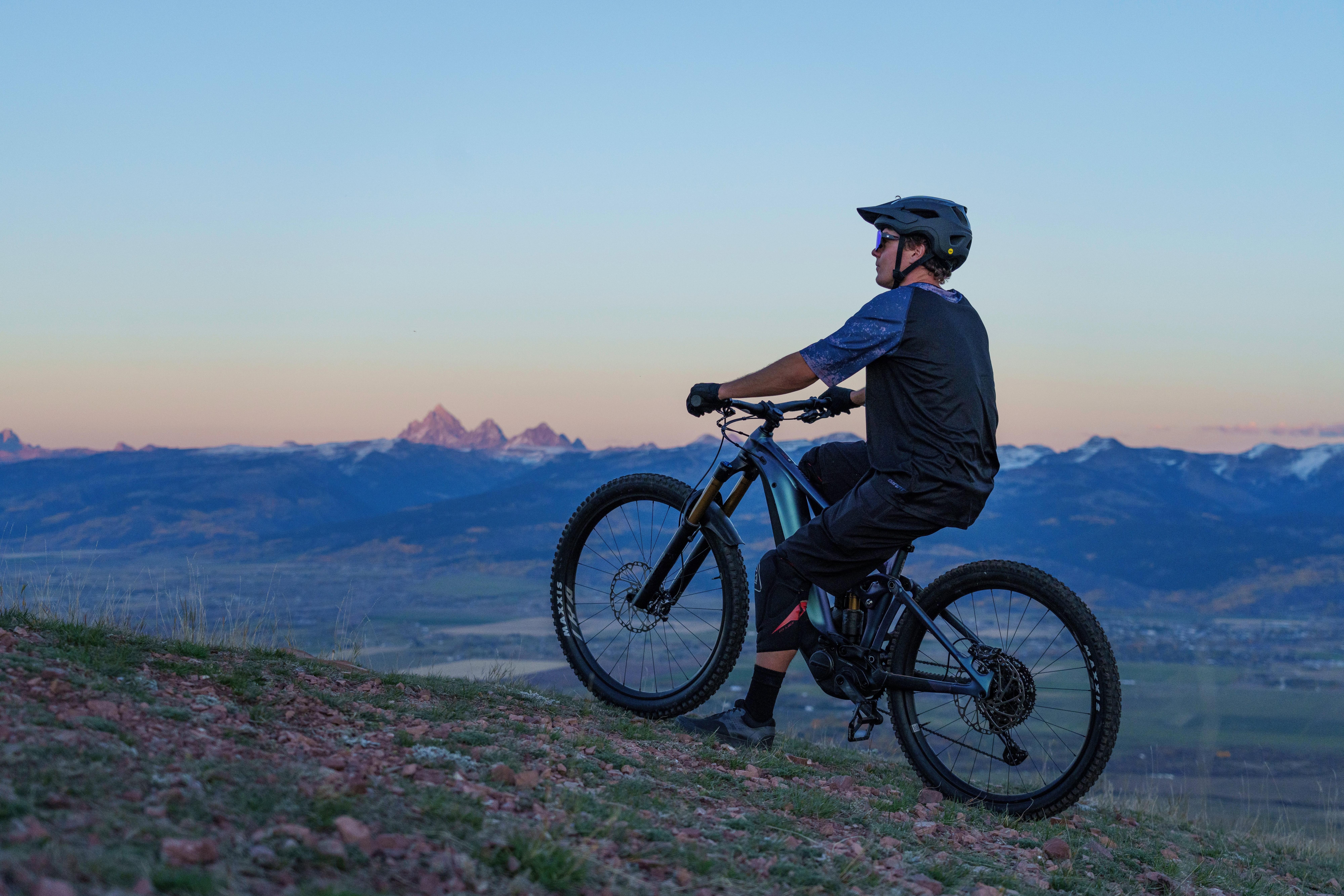 a man riding a mountain bike on a hillside
