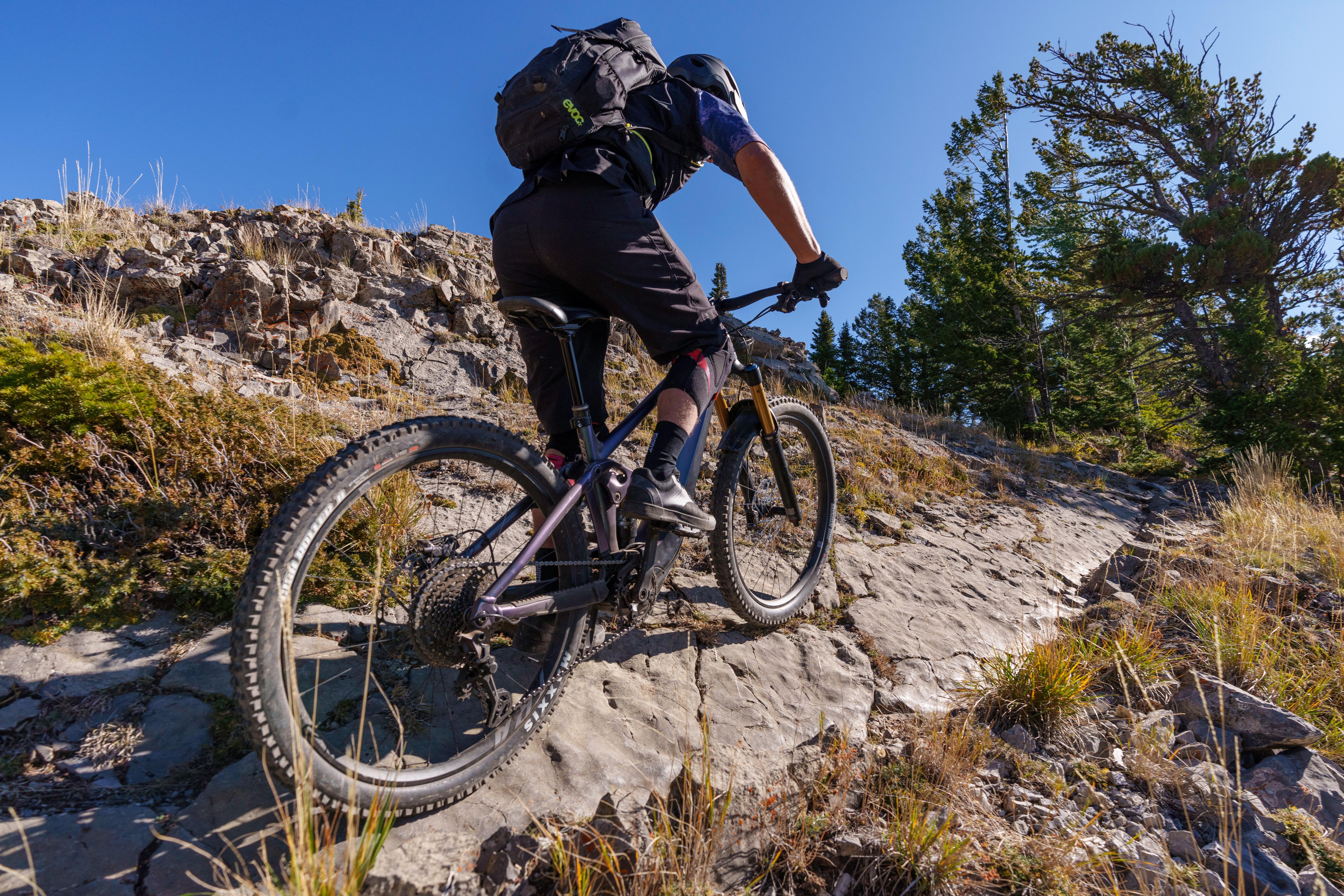 a man riding a mountain bike on a rocky trail
