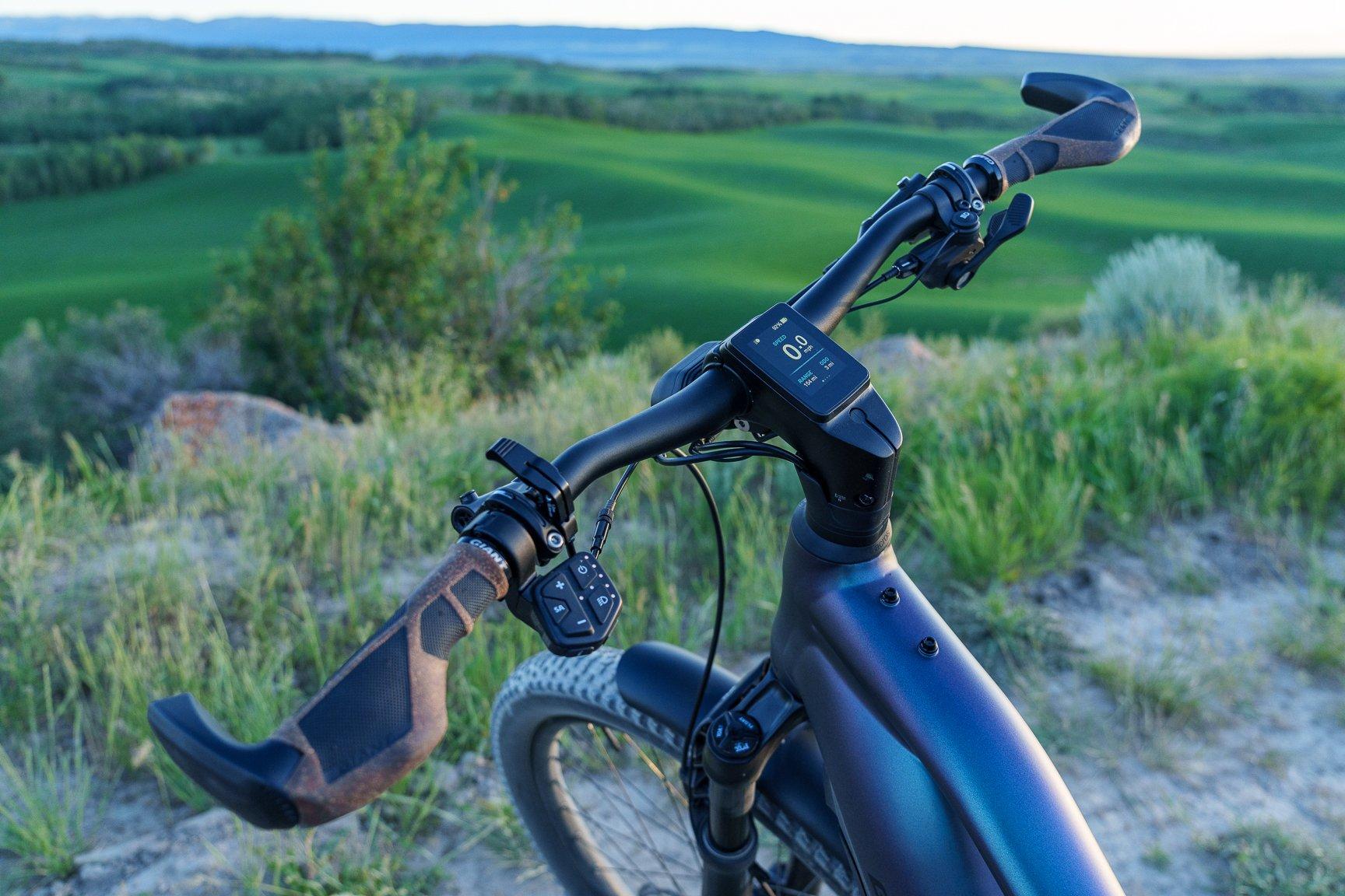a bicycle with a handlebar and a seat on a grassy hill