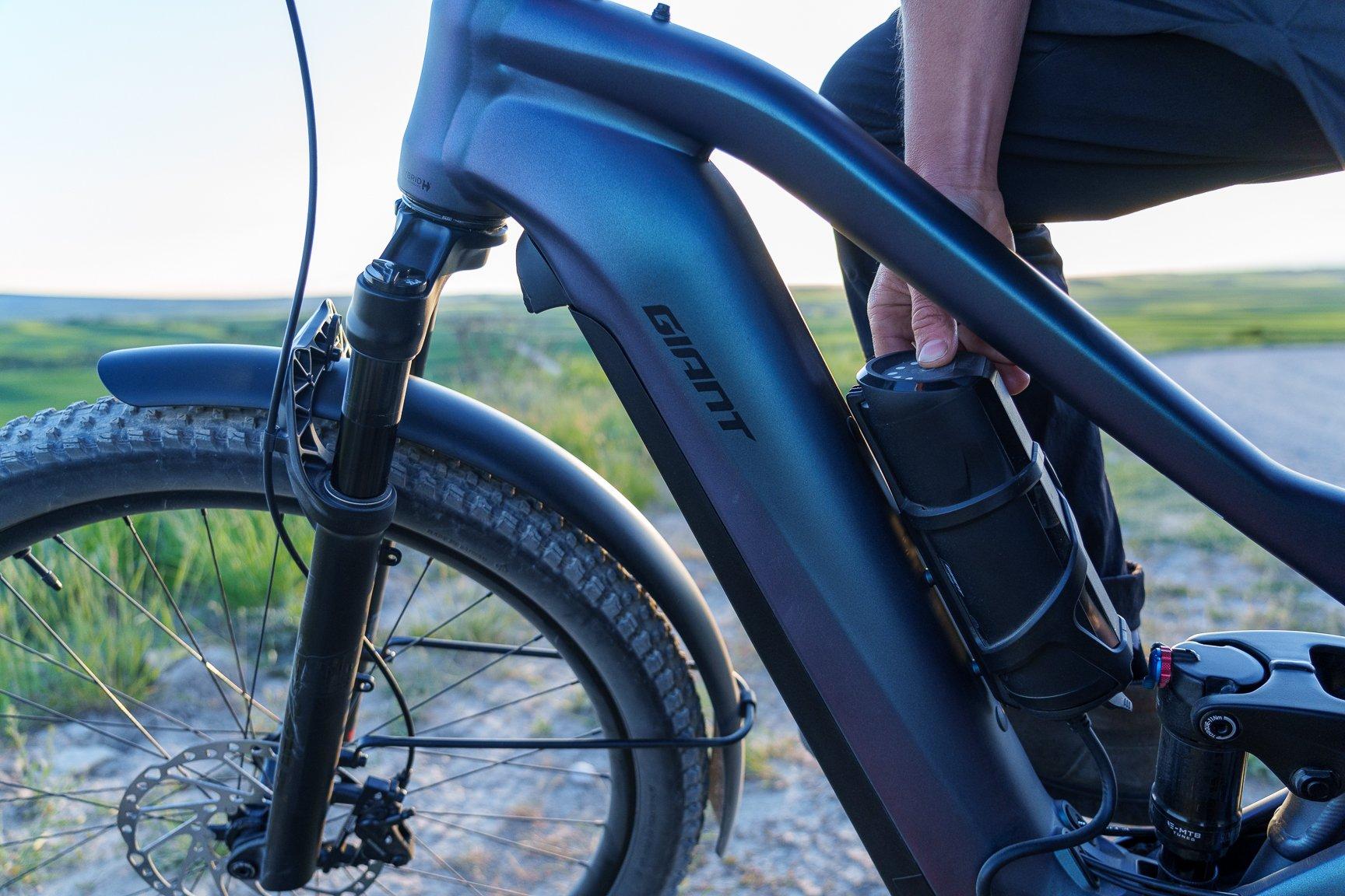 battery on an electric bike being turned on by hand