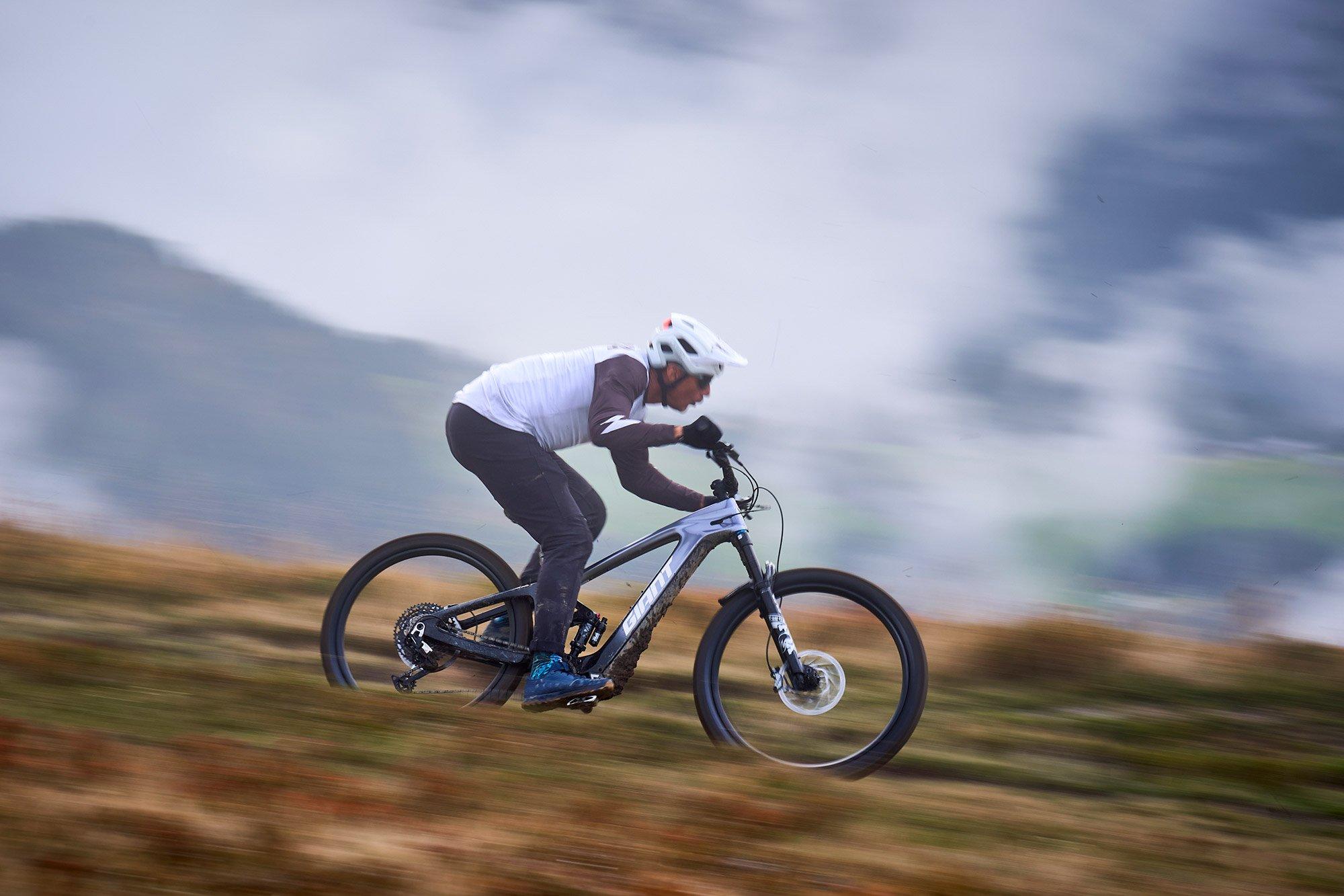 a man riding a mountain bike on a rocky hill
