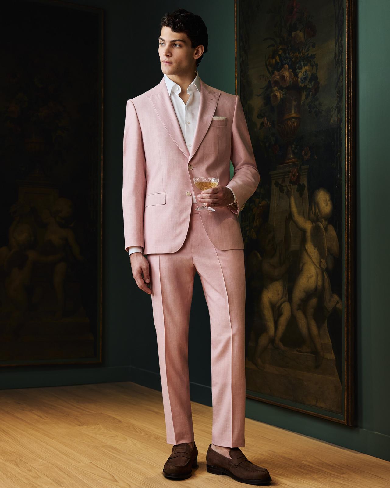 Male model wearing a pink BOSS suit 