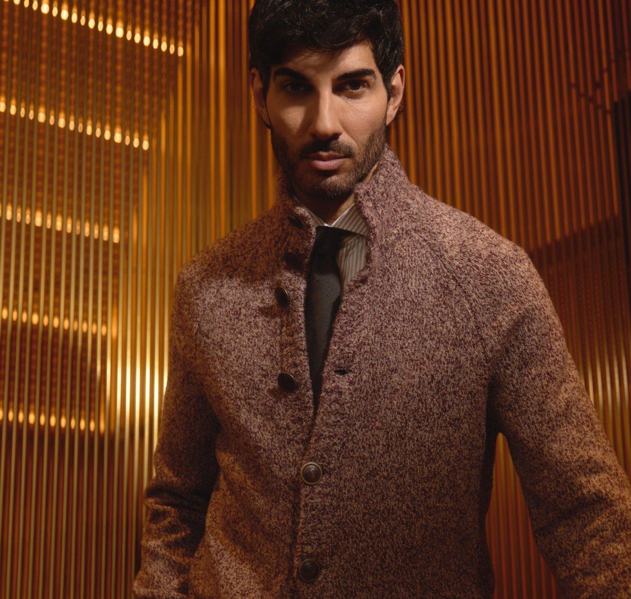 Male model wearing a sweater & tie