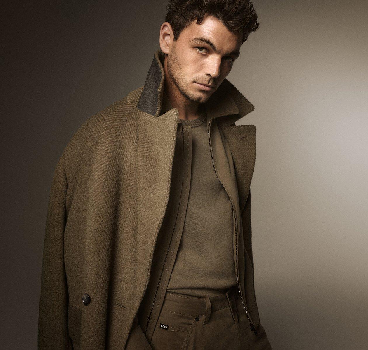 A man wearing a BOSS outfit in layered brown tones