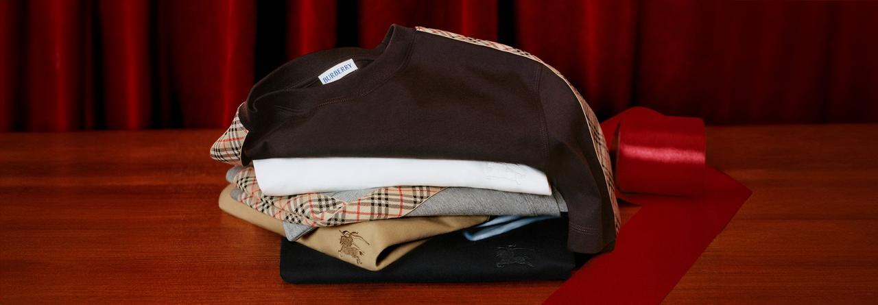 Burberry clothing displayed against a red background