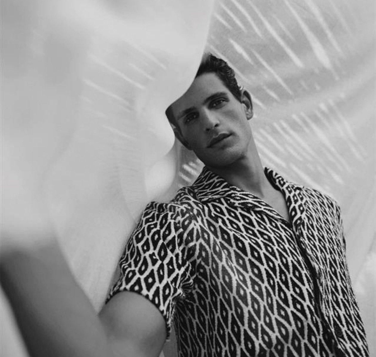 Male model wearing geometric sport shirt illustrating new swim and resortwear