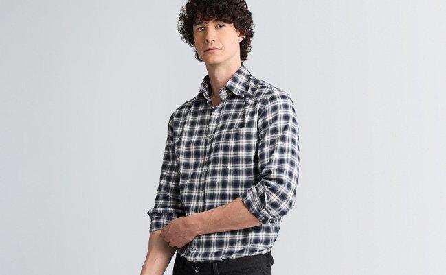 Male model wear a black and white checkered Paul & Shark casual shirt