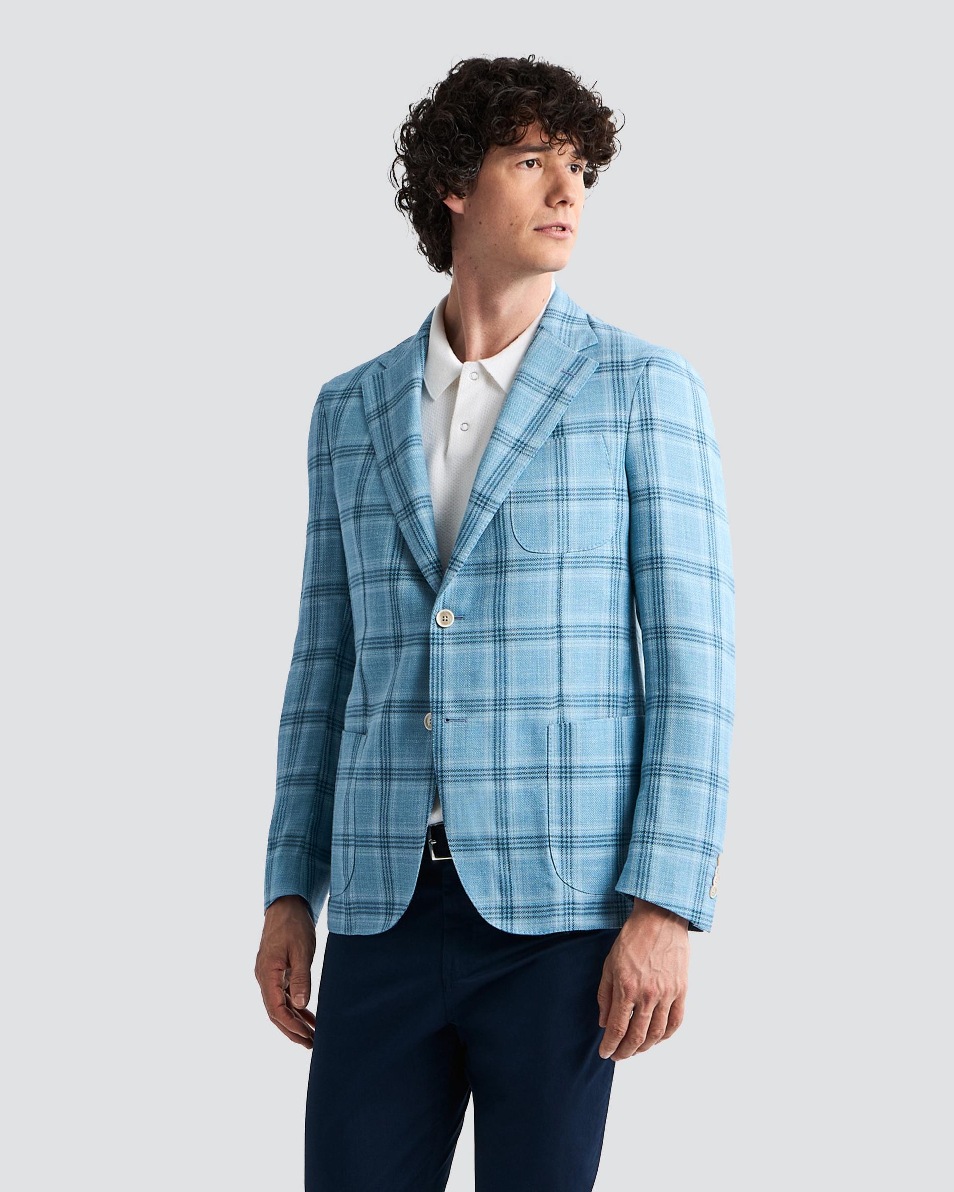 Male model wearing a sky blue checkered sport jacket at FinalCut by Harry Rosen