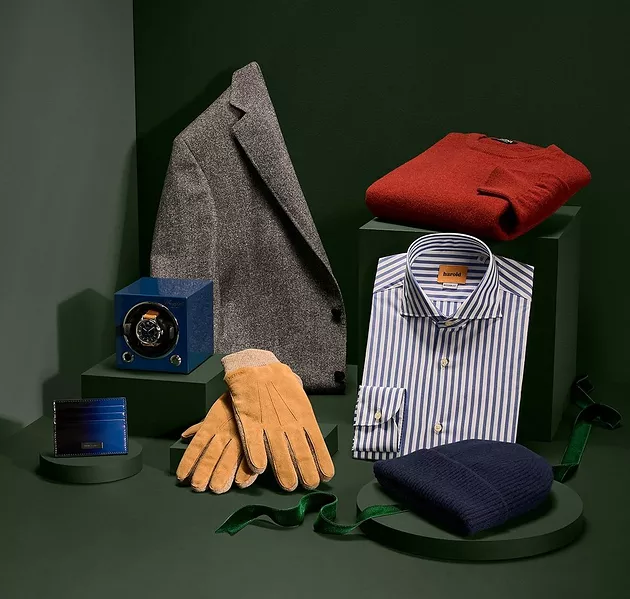 Grey overcoat, blue wallet, blue watch winder, tan suede gloves, stripped Harold dress shirt, navy hat, and red sweater