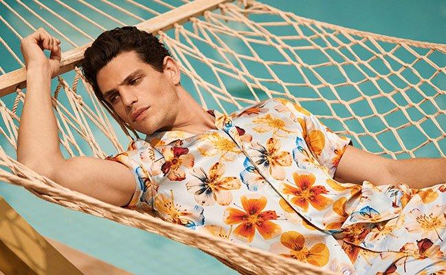 Male model wearing Orlebar Brown casual shirt on hammock to introduce the British brand