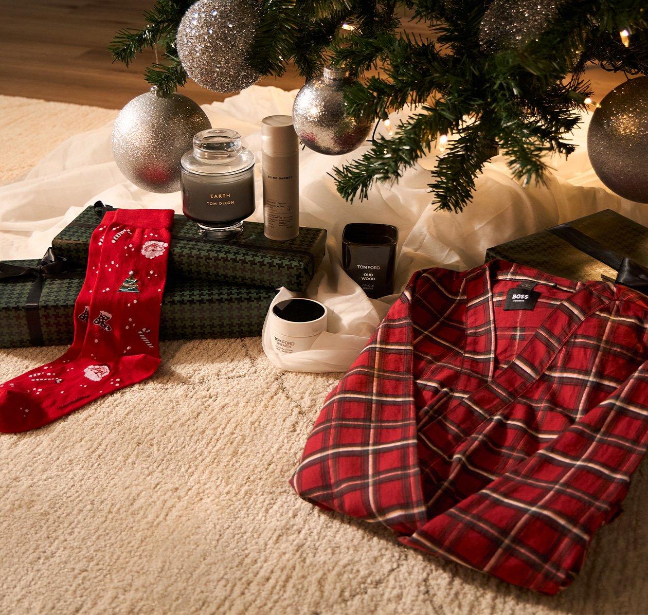 Gifts and accessories laid out under christmas tree signifying gifts for the homebody