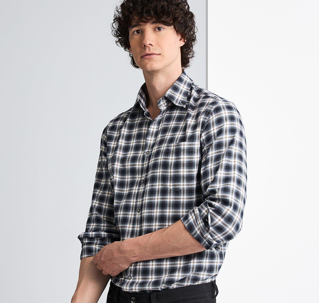 A male model wearing a black and white check casual shirt with brown accents