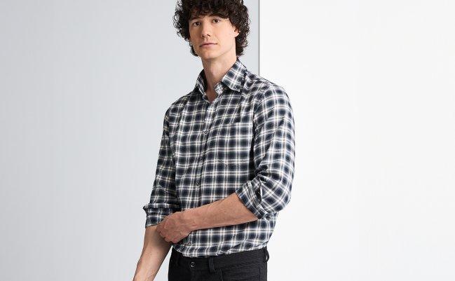 A male model wearing a black and white check casual shirt with brown accents