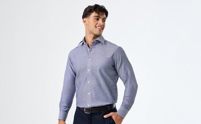 A male model wearing a blue dress shirt with white buttons