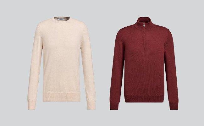 A burgundy wool 1/4 zip sweater and a cream wool sweater displayed on a grey background