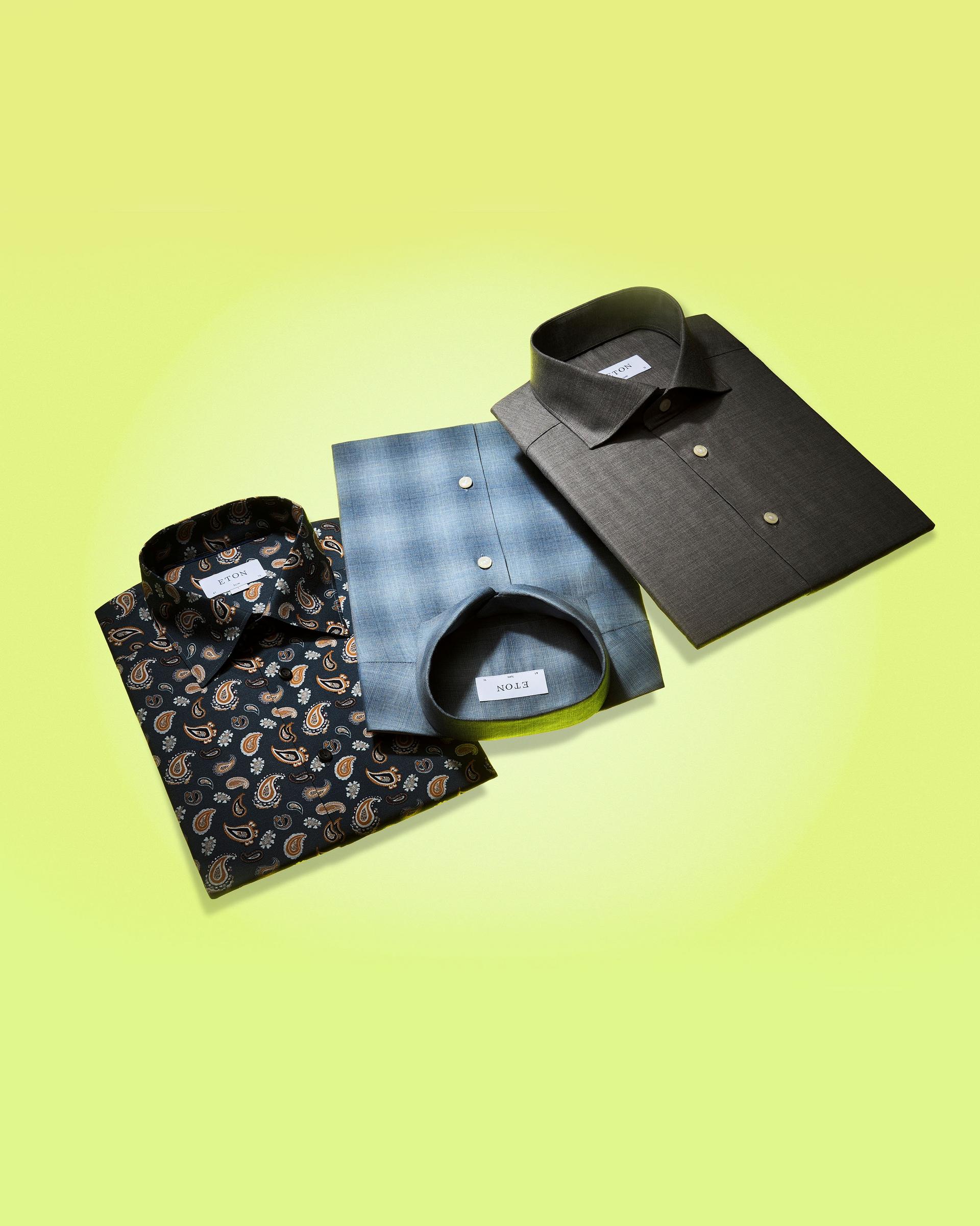 Three dress shirts on a lime green display