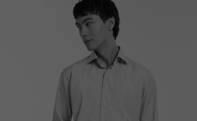 A male model wearing a black and white casual shirt