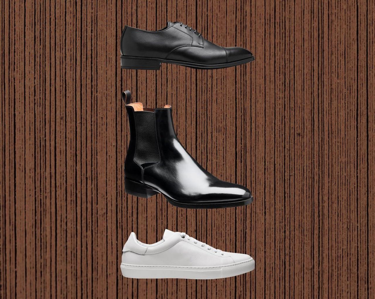White sneakers, black dress shoes and black boots on the brown background