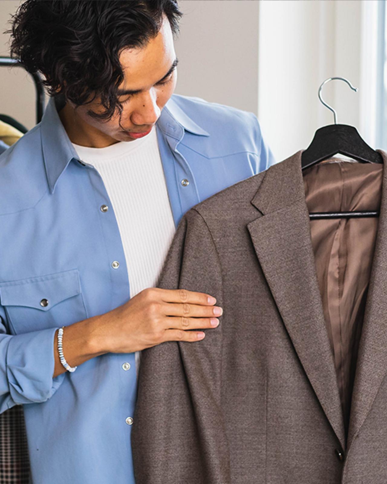 Style experts guiding customers through clothing selections at Harry Rosen