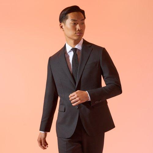 Man wearing a dark suit with a tie