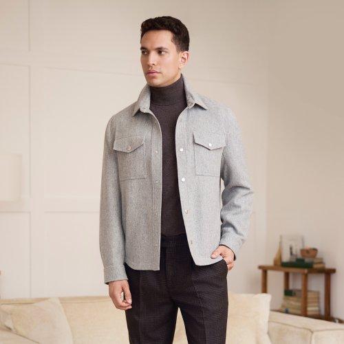A man wearing the cashmere overshirt with purple sweater
