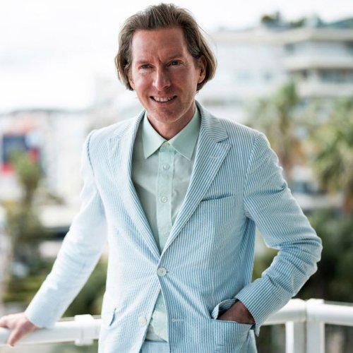 Wes Anderson wearing a tailored teal blue suit