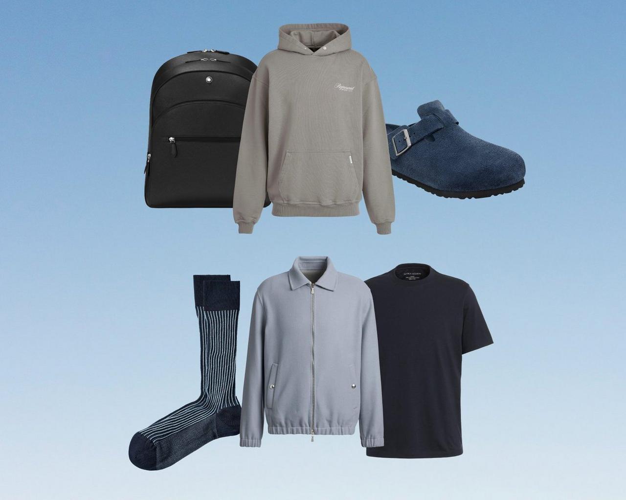 Travel essentials layout featuring a backpack, hoodie, socks, button-down shirt, and T-shirt on a blue background