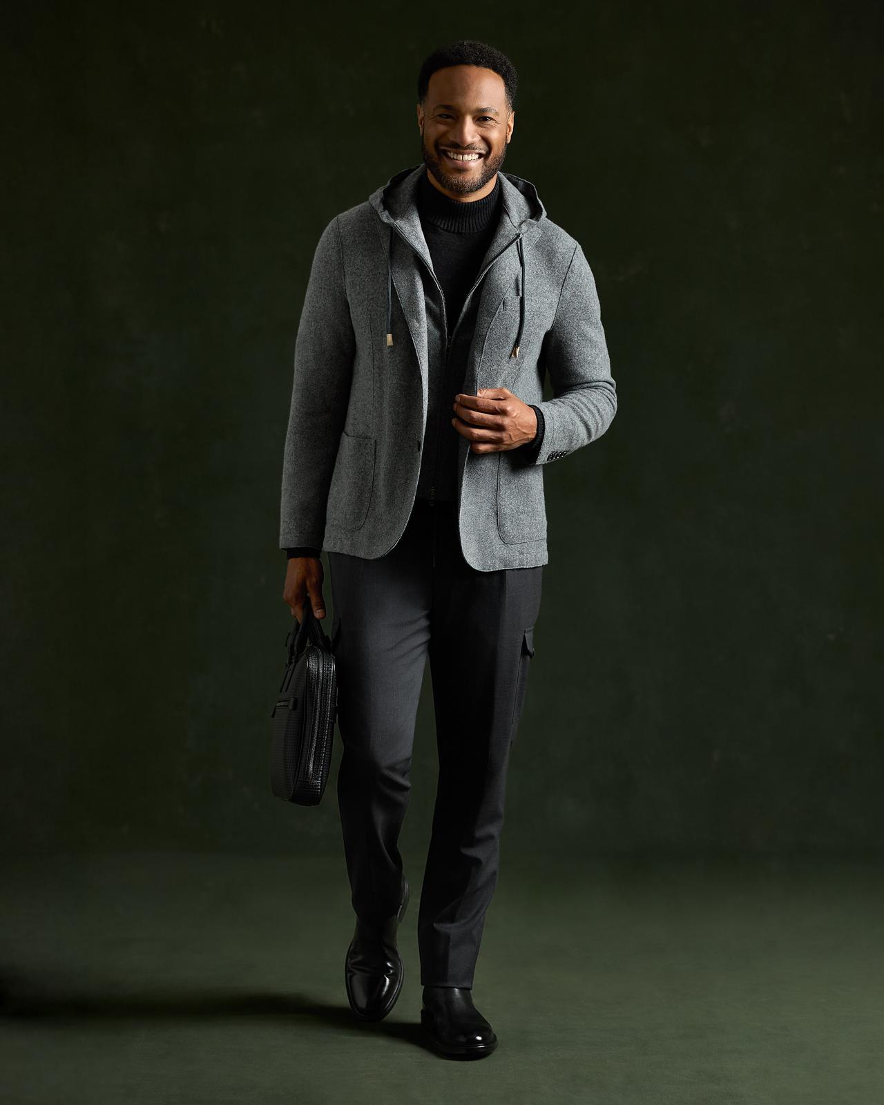 Mannequin masculin portant un chandail gris Patrick Assaraf et un pantalon noir, souriant