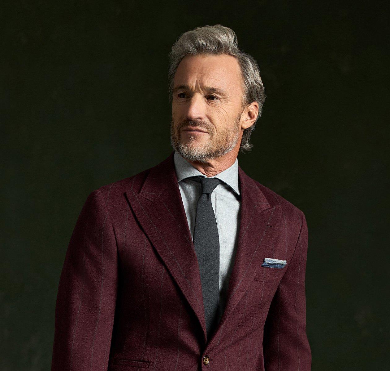 Male model wearing burgundy Brunello Cucinelli suit