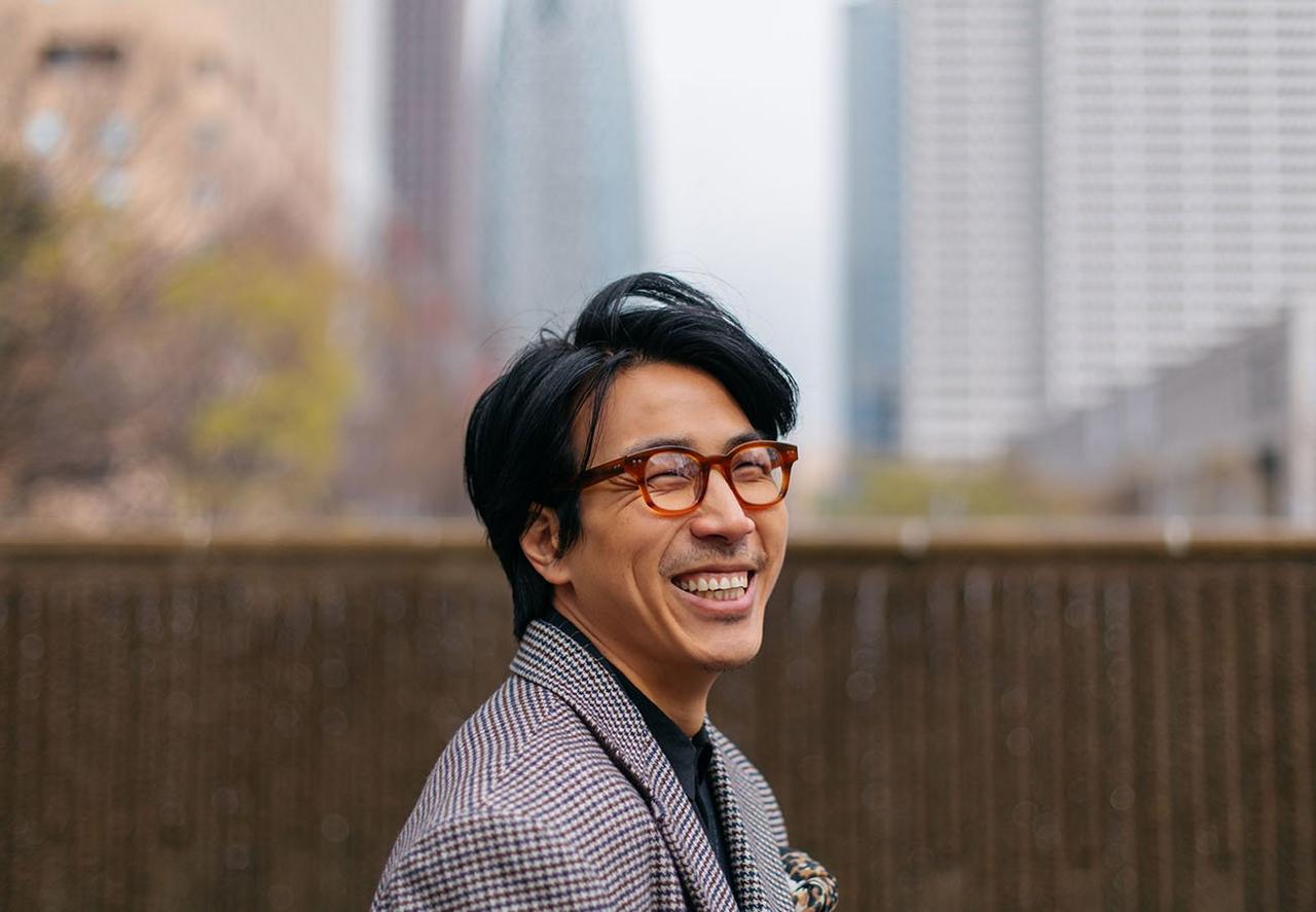 Male model smiling with city in the background