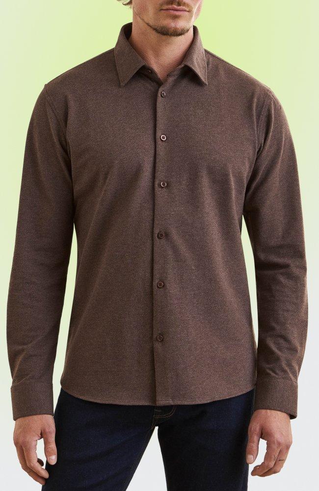 Man wearing a brown long-sleeve button-up shirt and dark navy trousers.