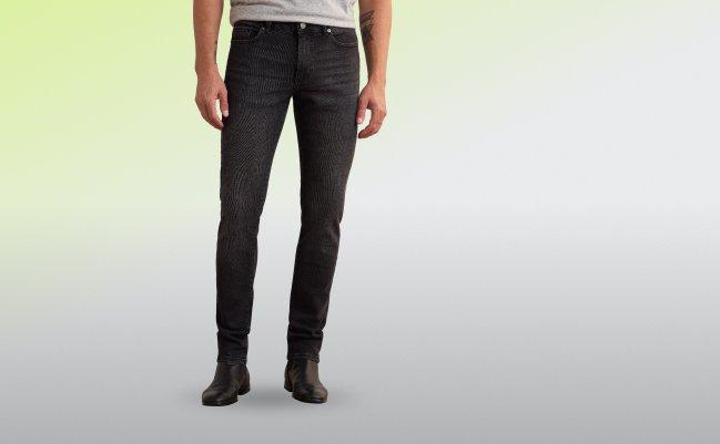 Un mannequin portant un jean noir ajusté à la coupe slim, avec un motif rayé subtil